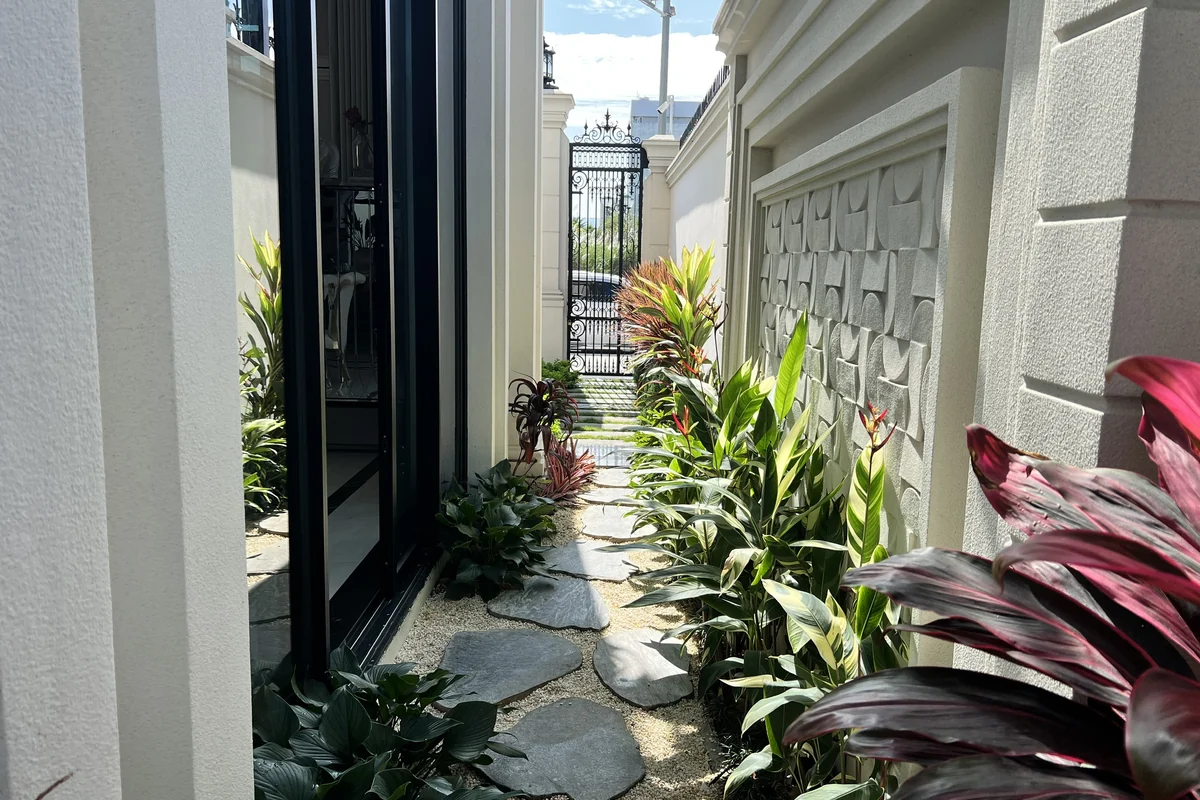 Giải pháp xanh hóa lối đi bên hông biệt thự hướng nắng bằng đá bước dạo tự nhiên và cây bụi chịu hạn